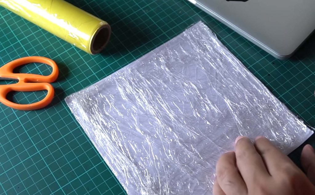 You use food wrap to carefully wrap the print - the-back-side- how to print a shirt